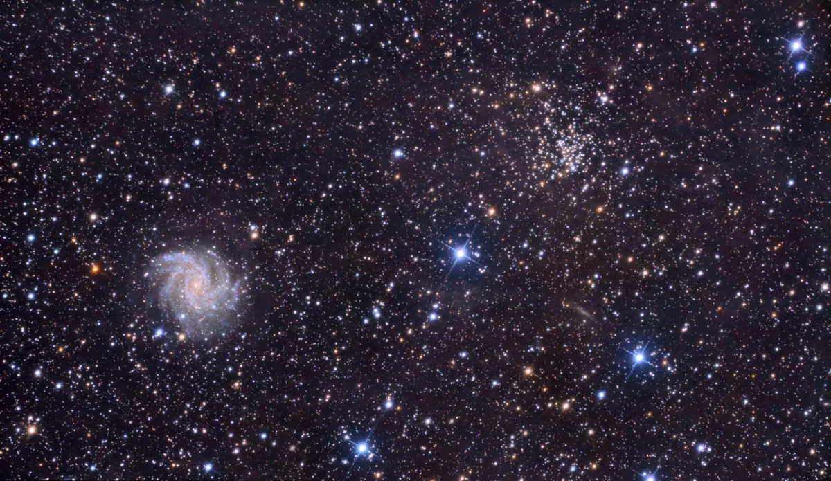 The Fireworks Galaxy with open cluster Jared Bowens, Clarksdale, Missouri, USA, 19 June–28 October 2022 Equipment: Canon 60D DSLR, Orion 8-inch f/3.9 Newtonian, Celestron AVX mount