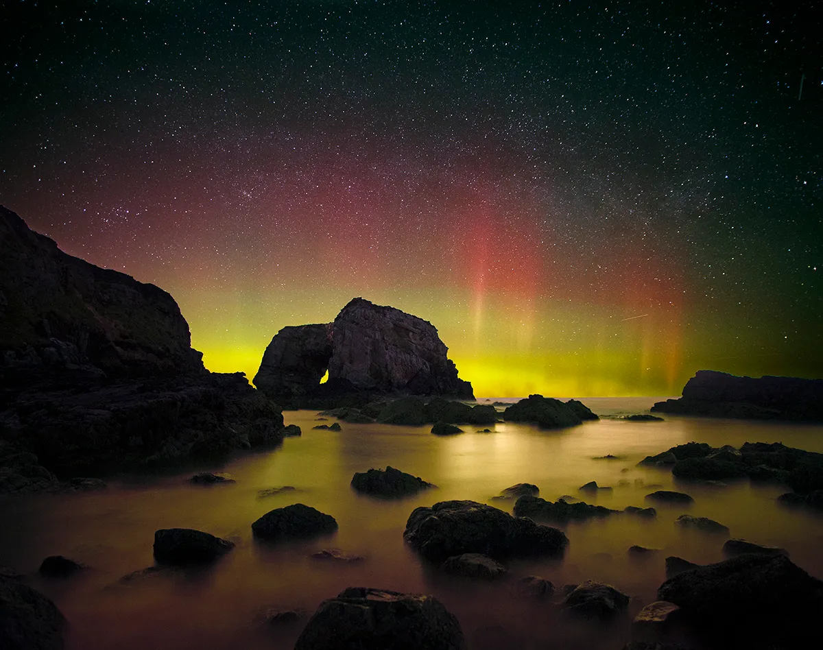 Aurora Over the Great Pollet Sea Arch, by Brendan Alexander, Great Pollet Sea Arch, Fanad Peninsula, County Donegal, Ireland Category: Aurorae Equipment: Canon EOS 6D camera, fixed tripod, Sigma 20 mm f/1.8 lens, 20 mm f/2.8, ISO 6400, 13-second, total exposure (two frames); Sky: 7.5-second exposure; Foreground: 5.5-second exposure