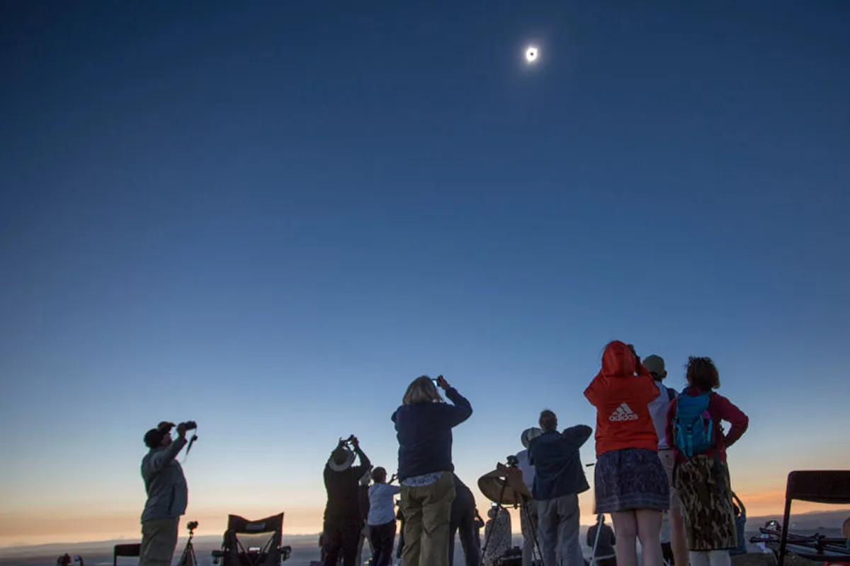 When photographing a solar eclipse, you could choose a setup that enables you to capture the wider picture, including fellow eclipse chasers in the foreground. Photo by Natalie Behring/Getty Images
