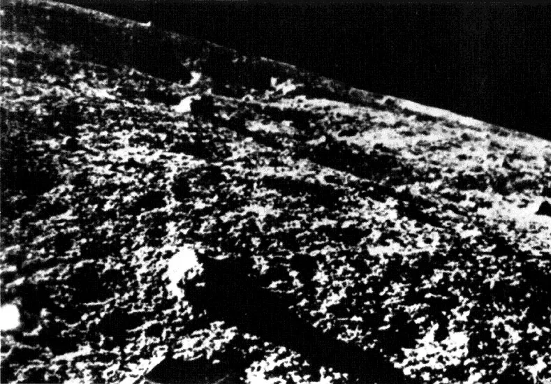 Grainy black and white image of the lunar surface.