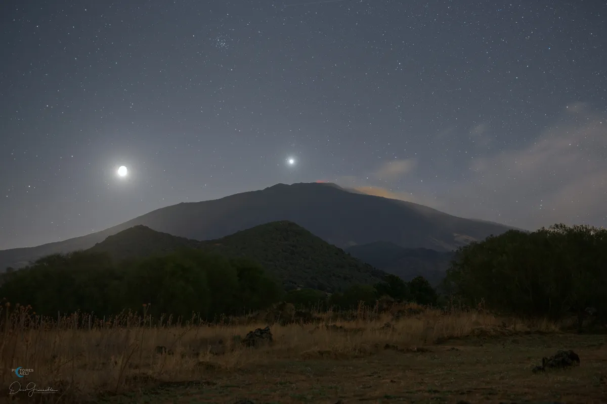 Image showing morning Venus with the Moon and M44 above Mount Etna. Captured by Dario Giannobile. Equipment: Canon EOS 6D DSLR camera, Sigma 50mm lens, f/2, 40 sec, ISO 800 for the landscape and ISO 400 for the sky (tracked)