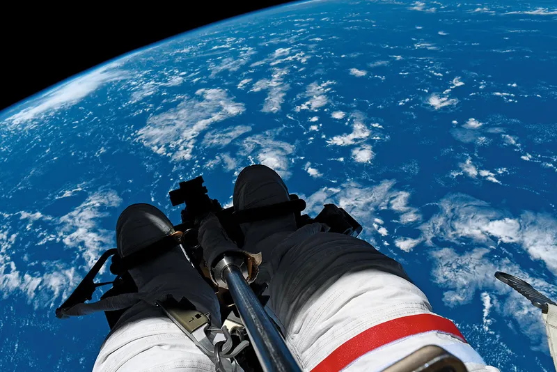The dangling feet of astronaut Thomas Pesquet during a spacewalk on the International Space Station, with Earth below. Captured by ESA astronaut Thomas Pesquet, featured in his book The Earth in Our Hands. Credit: Firefly Books