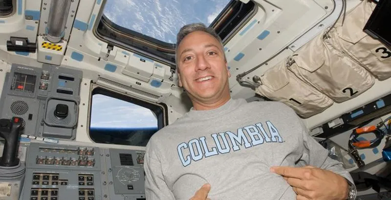 NASA astronaut Mike Massimino pictured in his Columbia University sweater on board the Space Shuttle. Credit: NASA