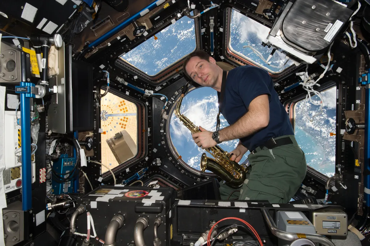 Thomas Pesquet plays saxophone in the Cupola module on the International Space Station, 31 May 2017. Credit: ESA/NASA