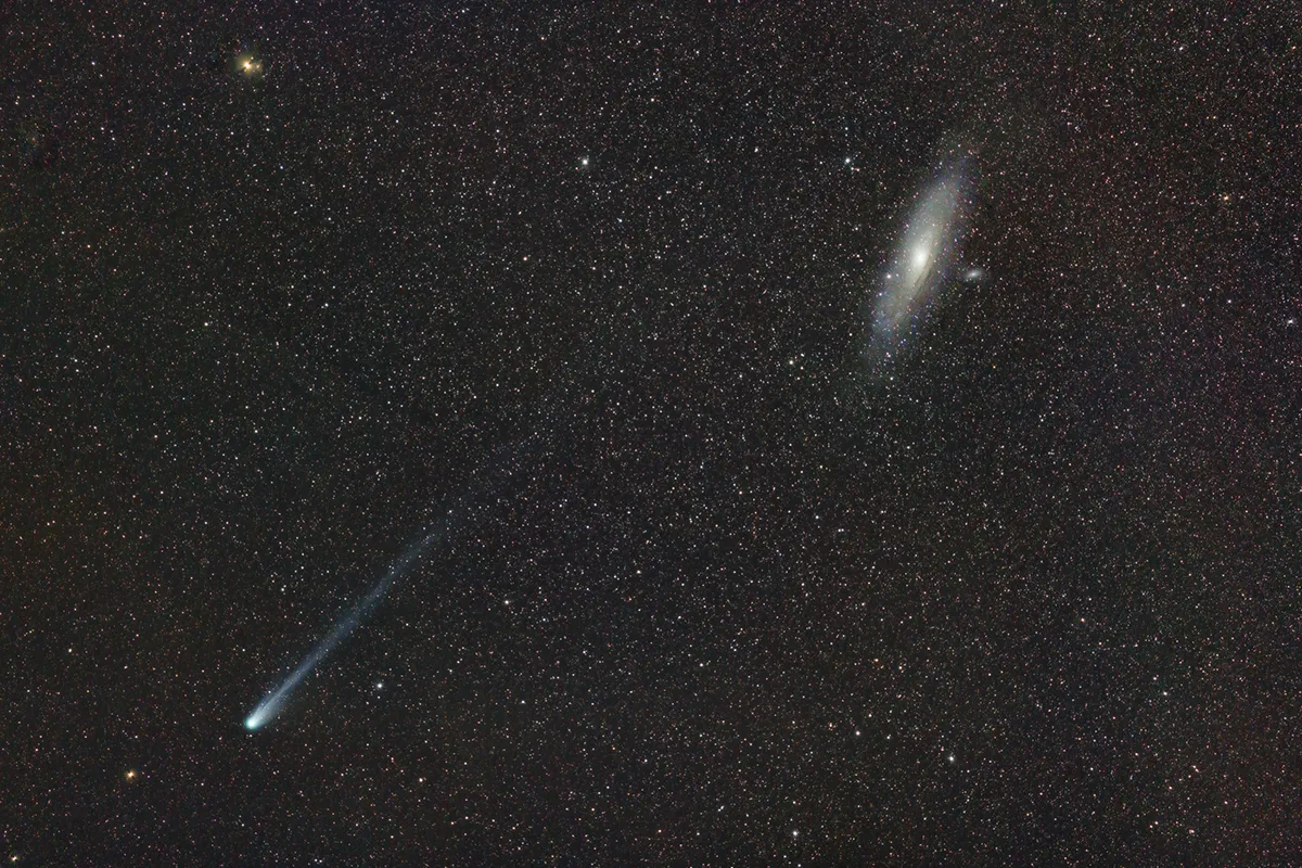 Comet 12P/Pons-Brooks and the Andromeda Galaxy, by José J. Chambó, Sierra de Enguera, Valencia, Spain, 12 March 2024. Equipment: Canon EOS 6D DSLR camera, Samyang F2.0/135mm lens, Meade LXD-75 mount. Exposure 40 min. (40x60 sec. at ISO 800). Processed with PixInsight. Credit. José J. Chambó (www.cometografia.es)