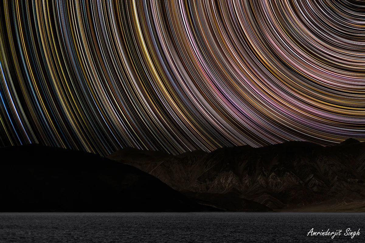 Star trails captured by Amrinderjit Singh, Pangong Lake. Equipment: Canon R mirrorless camera, Canon EF 50mm lens, 260x30s, ISO 800, f/2.8. Click to expand.