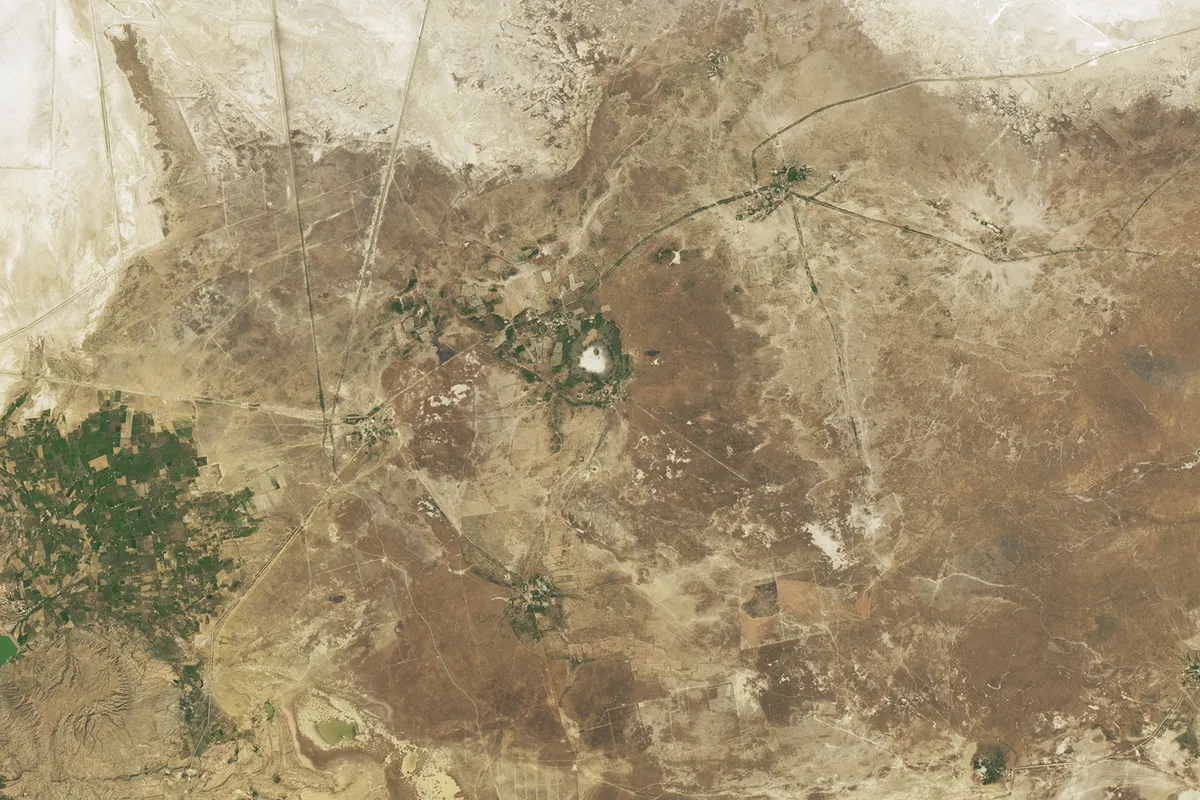 The region surrounding India's Luna impact crater, the white mark in the centre of the image. NASA Earth Observatory image by Michala Garrison, using Landsat data from the U.S. Geological Survey.