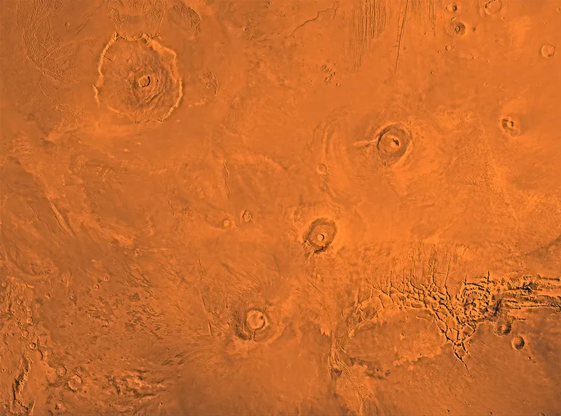 The Tharsis region of Mars showing the Tharsis bulge, a huge ridge covered by 3 large aligned Tharsis Montes shield volcanoes. Credit: NASA/JPL-Caltech/USGS