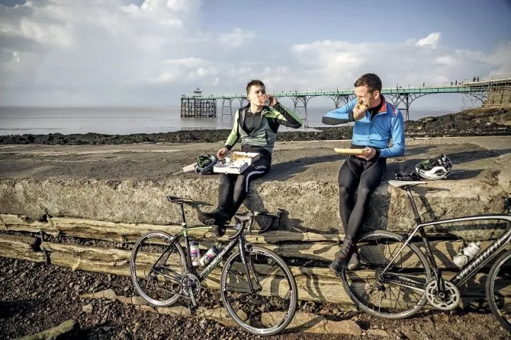 Two cyclist's have lunch on the seafront at Clevedon in Somerset
