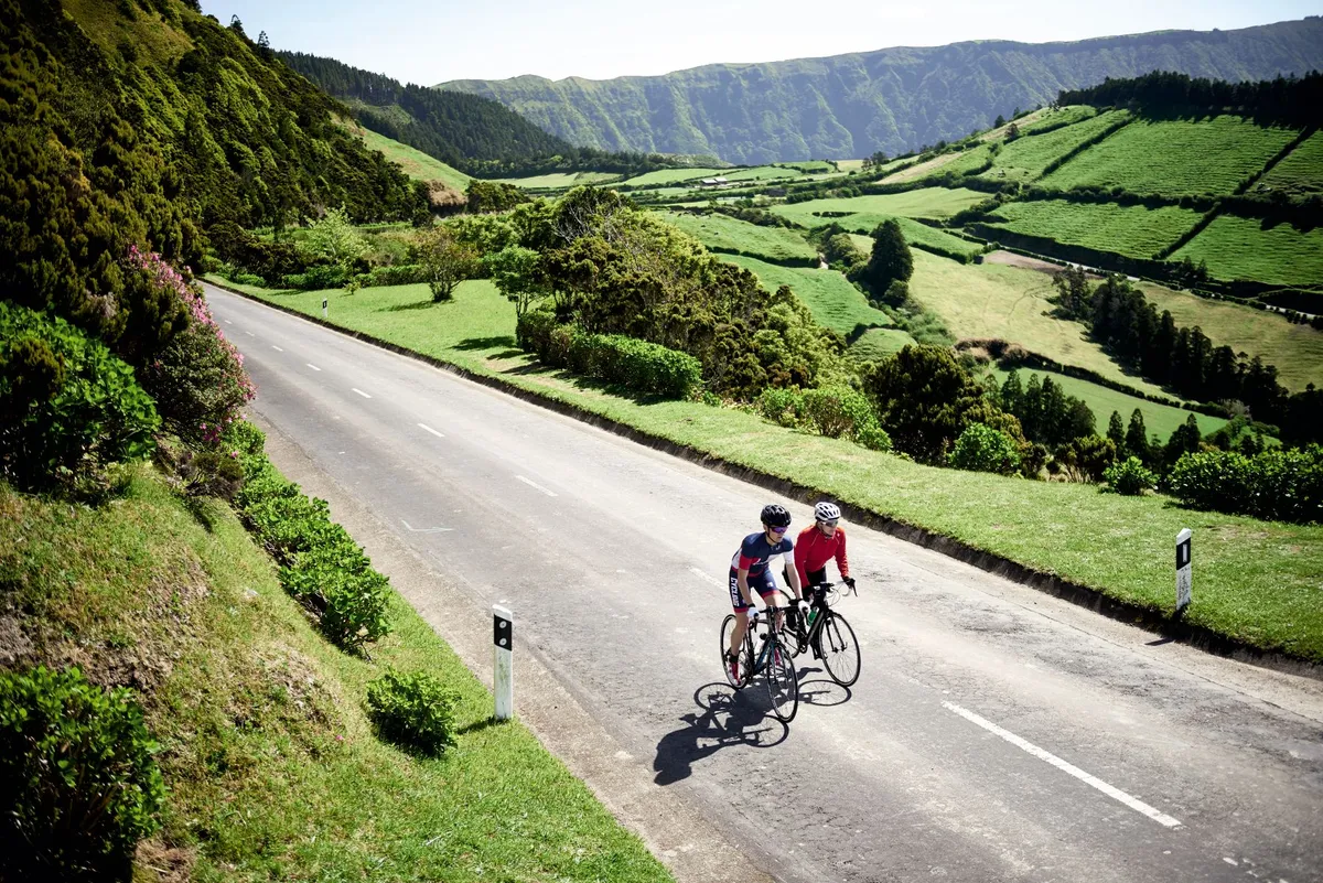 Two cyclists riding in the Azores