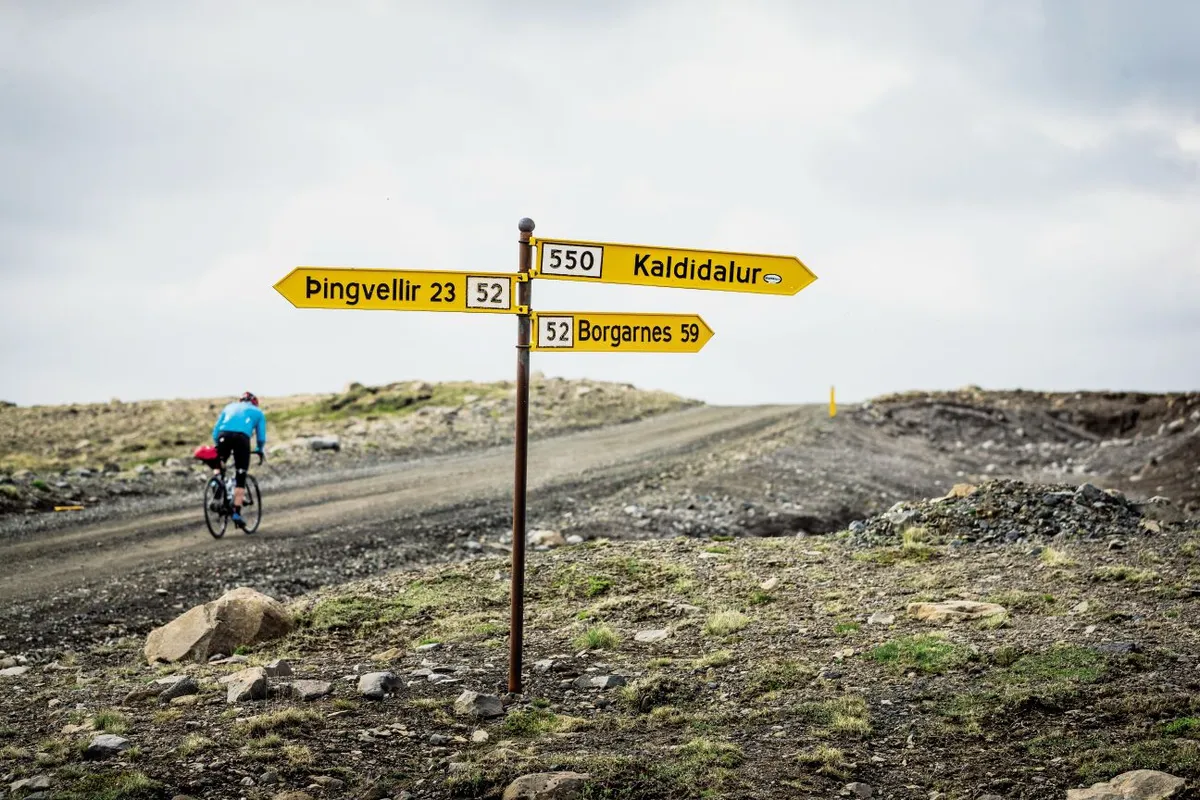 Cycling past roadsigns in Iceland