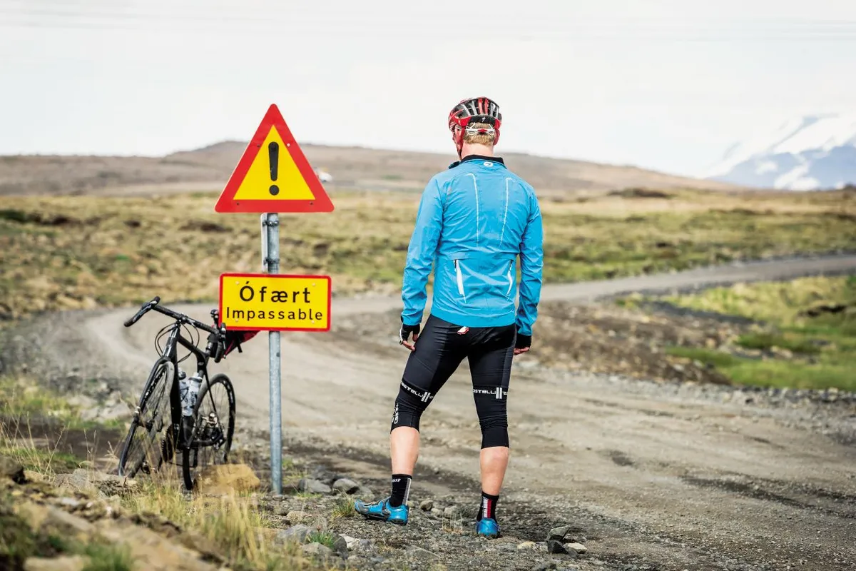 An Icelandic road sign and a cyclist