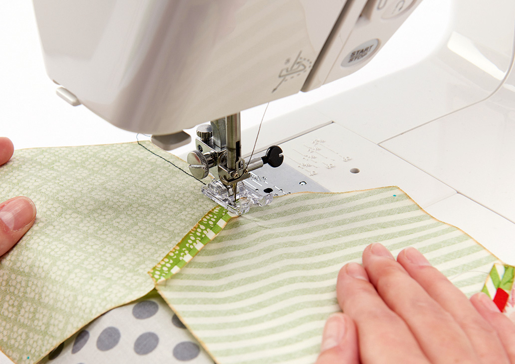 hexagon quilting tutorial step 4 – hexagons under a sewing machine
