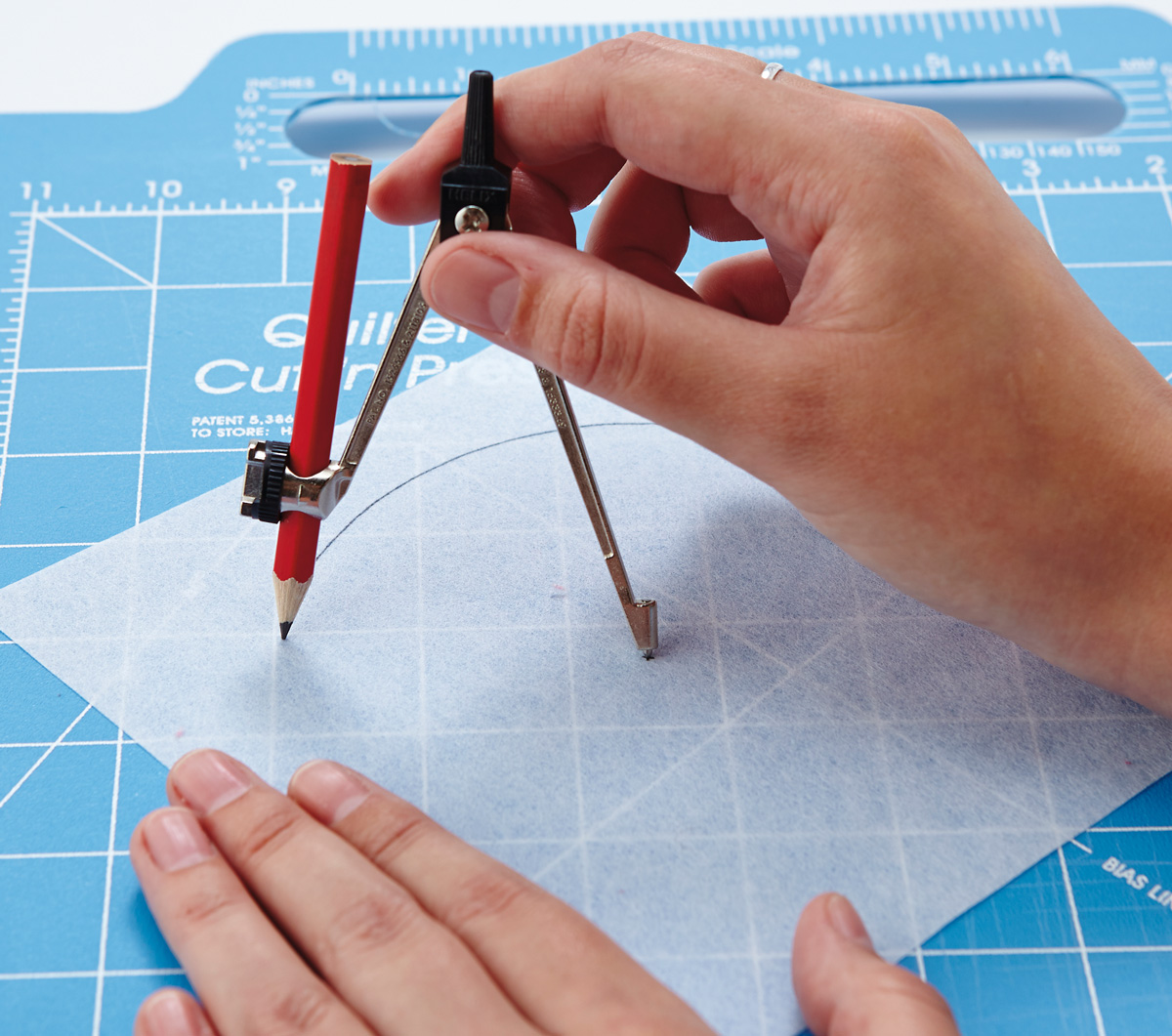 drawing a template using a compass on a cutting board