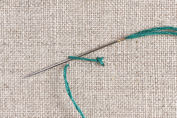 Needle threading under stitch