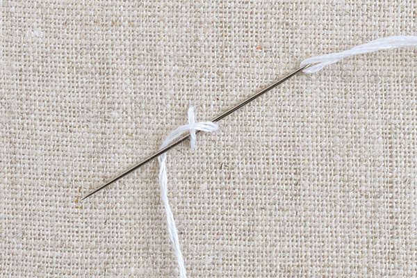 needle and thread demonstrating four legged knots