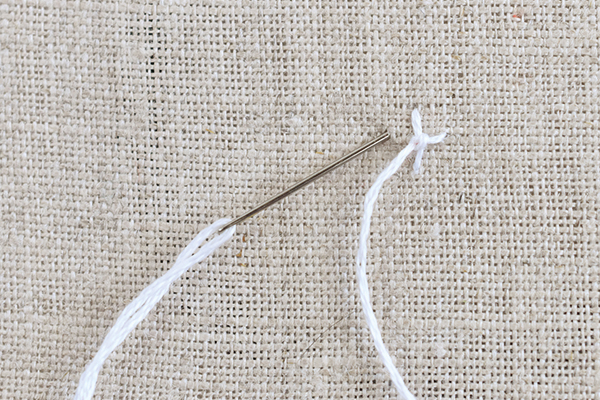 needle and thread demonstrating four legged knots