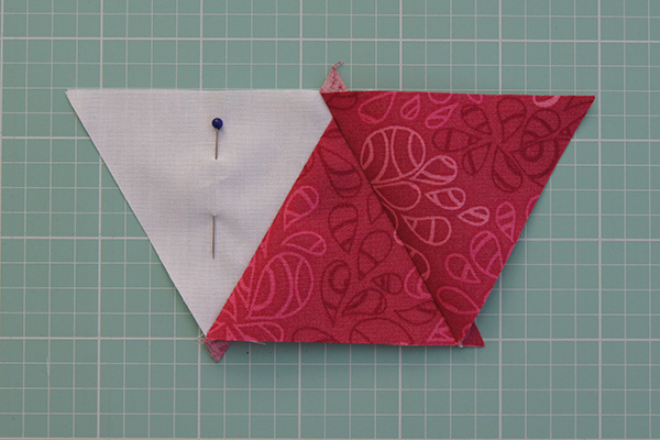 Step nine: Repeat step eight to add the remaining triangles to the row. Once you have sewn the entire row, press the seams and trim off any dog ears. Step ten: Repeat steps 6–9 to make the remaining rows. Alternate rows will start with a triangle that’s orientated in the opposite direction to the previous row. Fig F Step 11: Join the rows, making sure you carefully pin the points of your triangles in place before you sew. Press the seams open. Step 12: Trim the cushion top to 161⁄2in square, making sure to leave a 1⁄4in seam allowance to avoid losing the points of the triangles when binding. Fig E