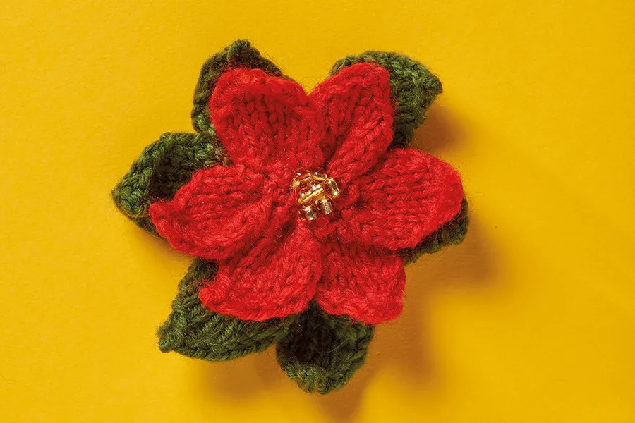 Knitted flower brooch poinsettia