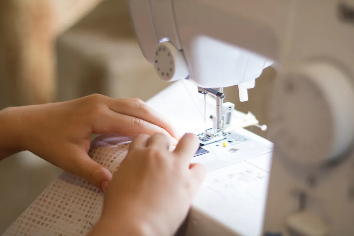 Closeup of child at sewing machine