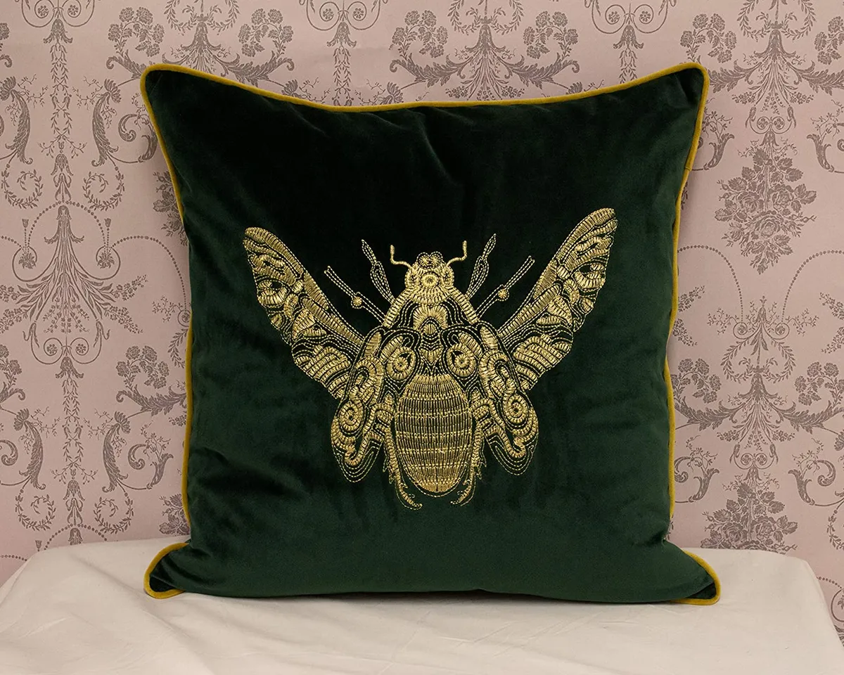 embroidered cushion with bee pattern