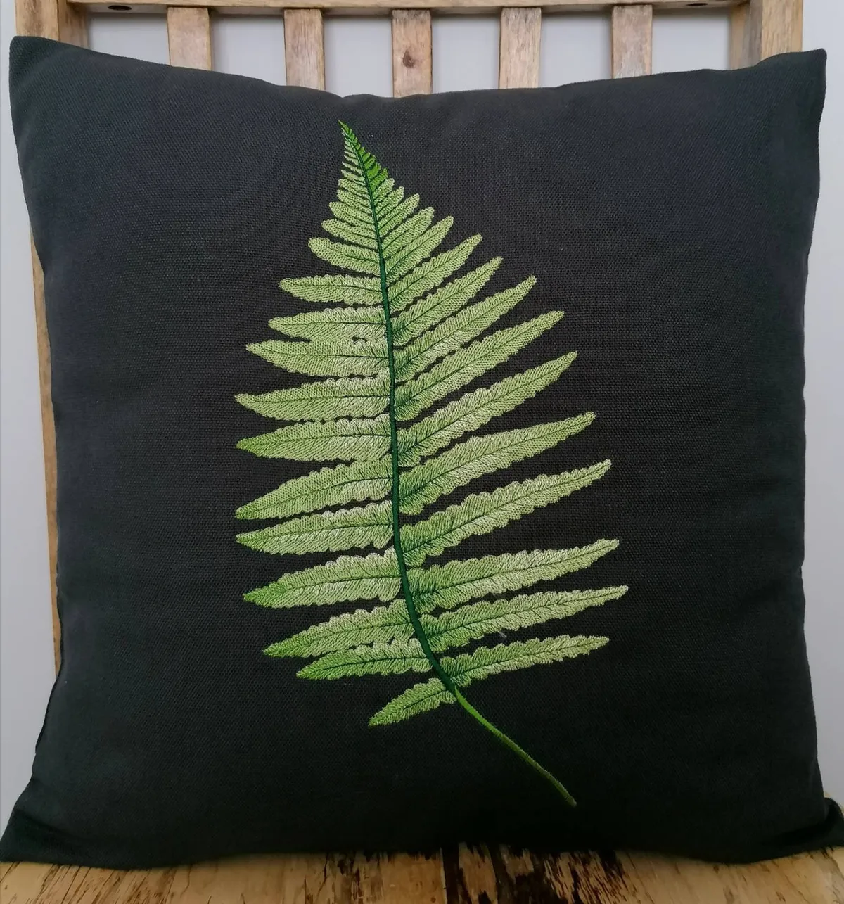 embroidered cushion with fern pattern