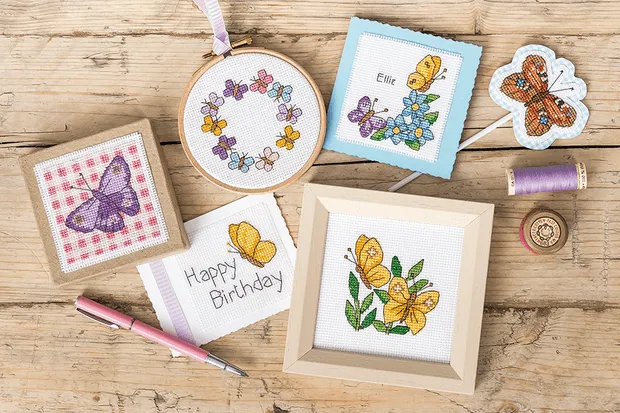 a selection of spring cross stitch patterns including cards and boxes featuring butterflies