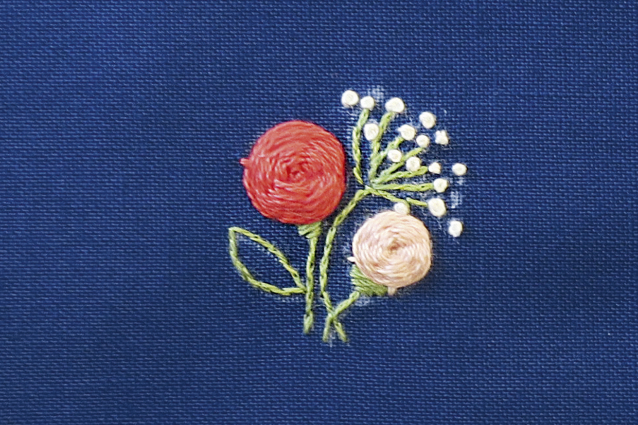 woven wheel stitch on a blue fabric