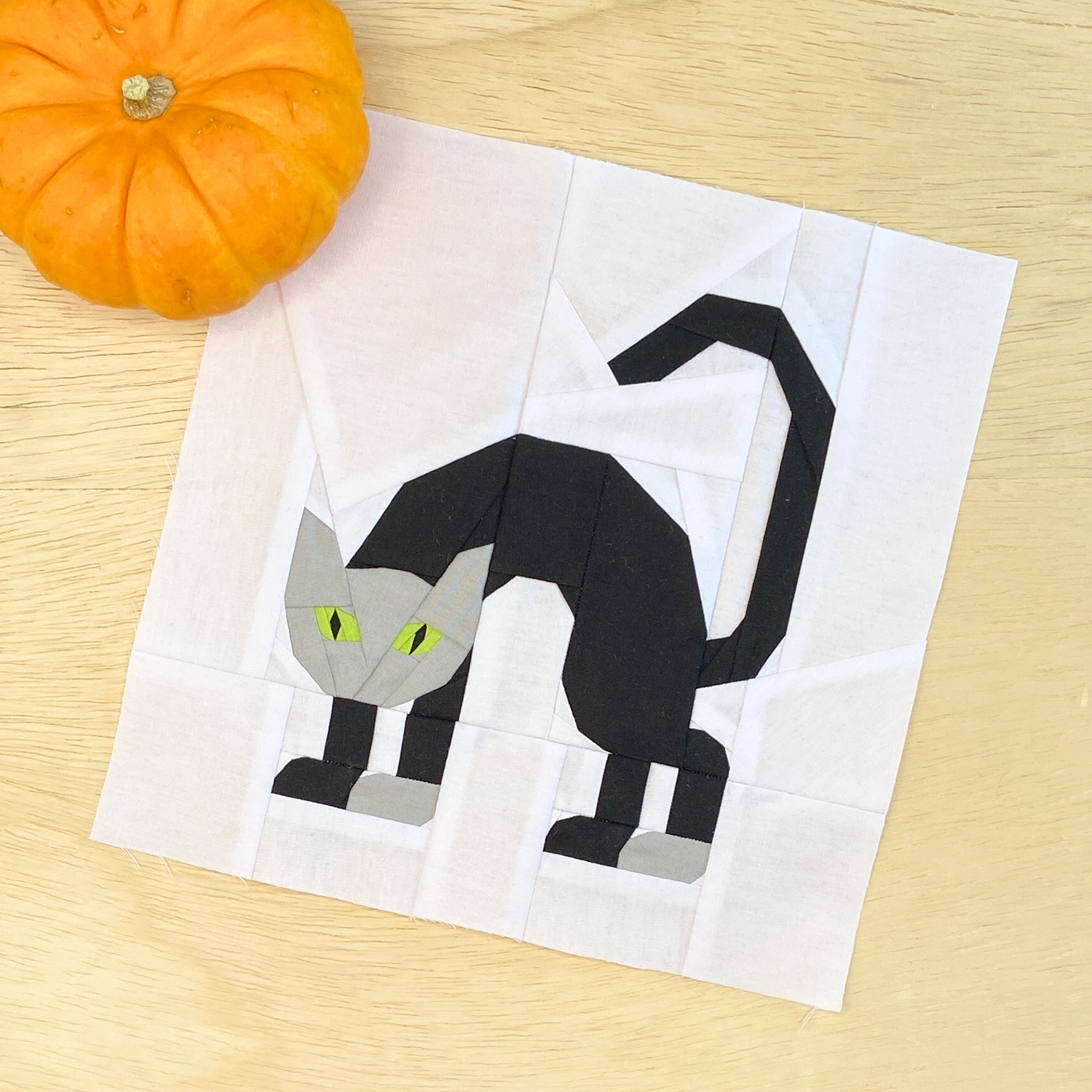 a black cat with arched back features in this cat quilt block