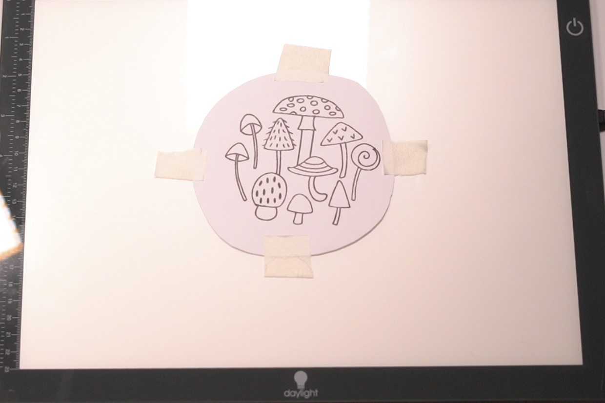 Embroidery pattern on top of a lightbox