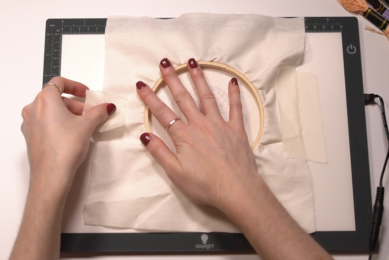 Taping an embroidery hoop to a lightbox