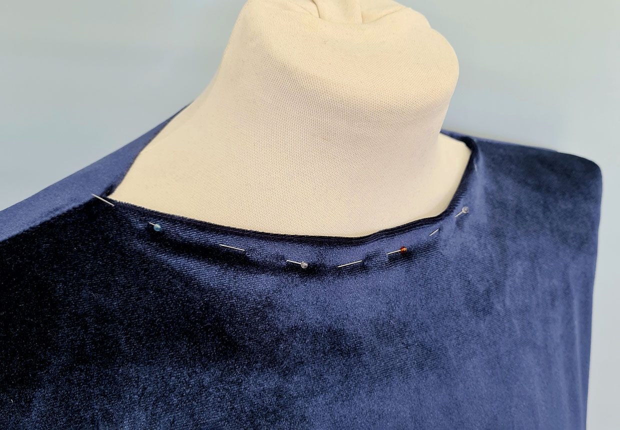 Try the garment on and tuck the raw edge of the neckline (front and back) to the inside of the garment