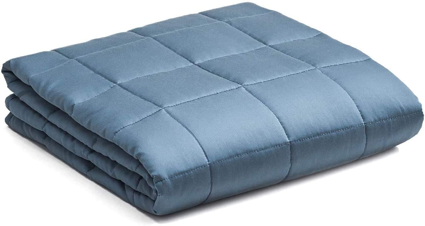 the weighted blanket uk us made from pale blue fabric with a slightly sheen and is folded neatly into a square shape