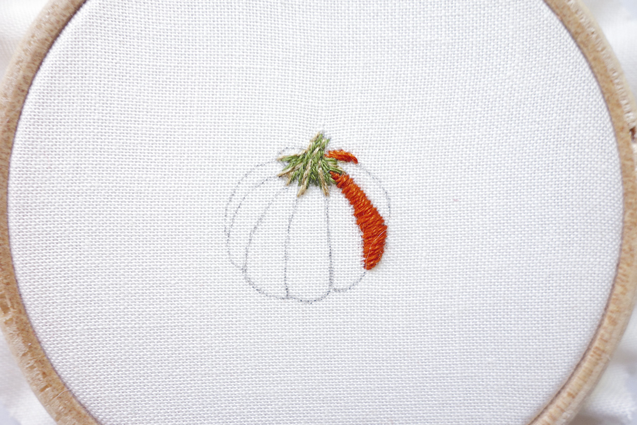 An embroidered pumpkin with satin stitch