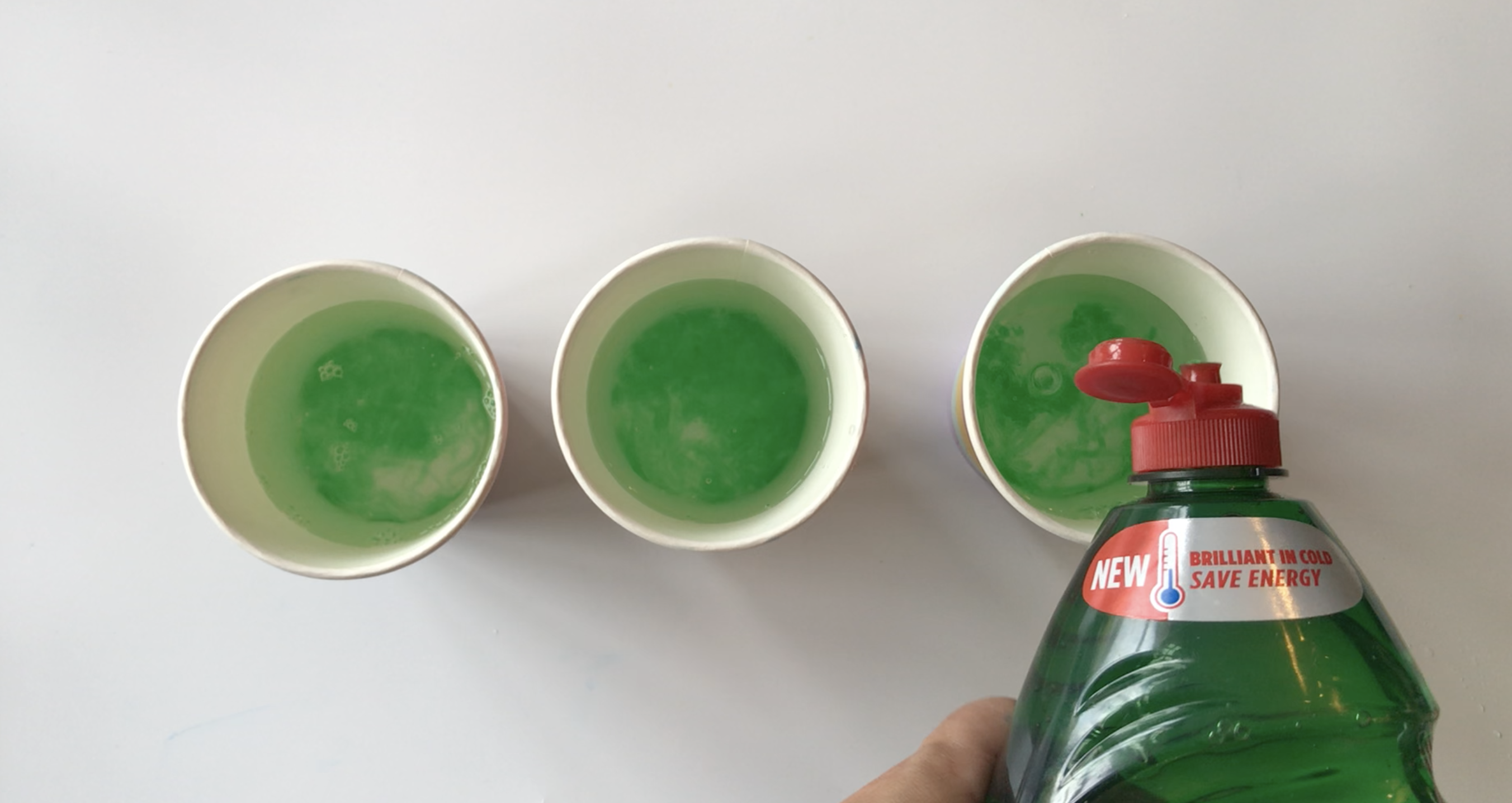 Squirt some washing up liquid into each cup