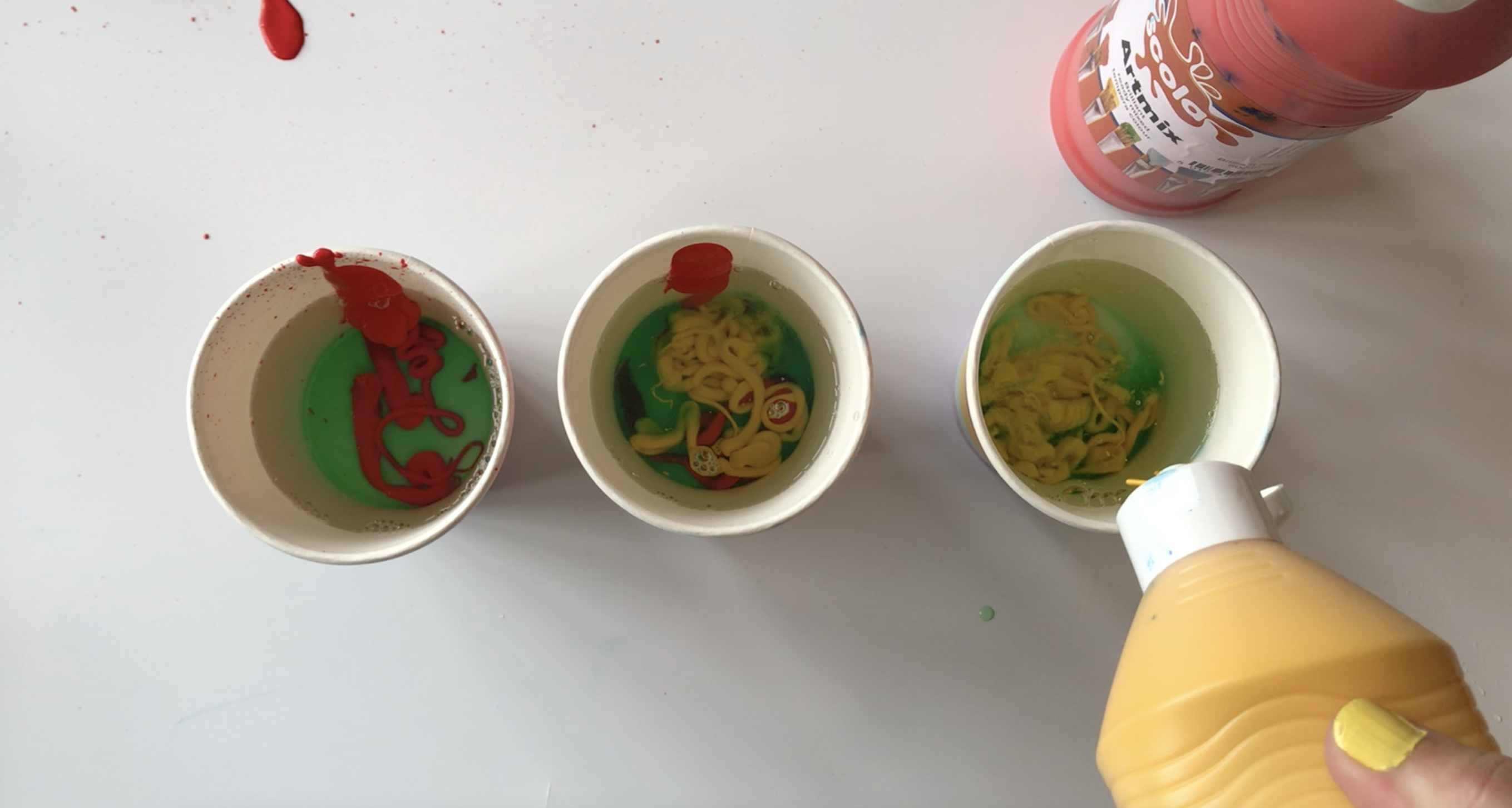 Add some paint into each cup
