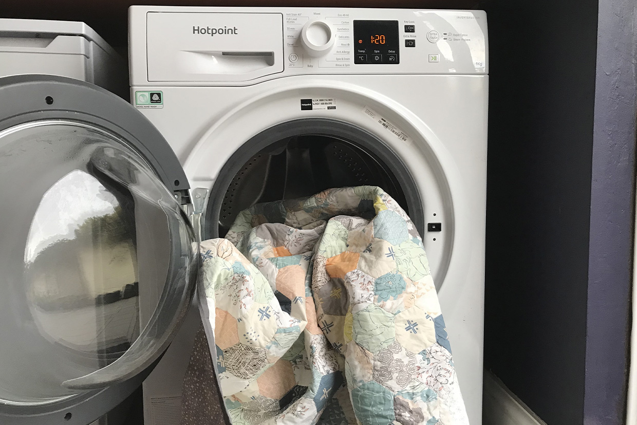 quilt half in an open washing machine