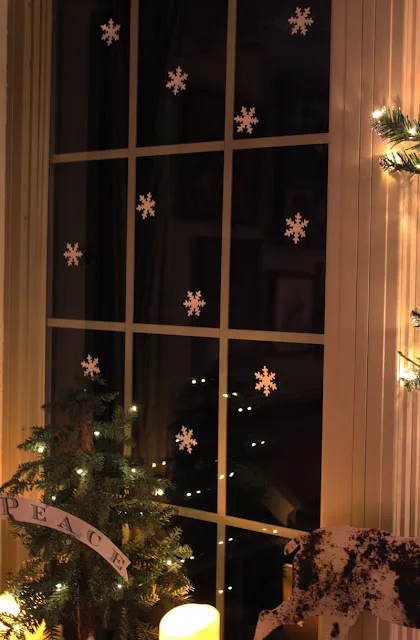 mini paper snowflakes on a window