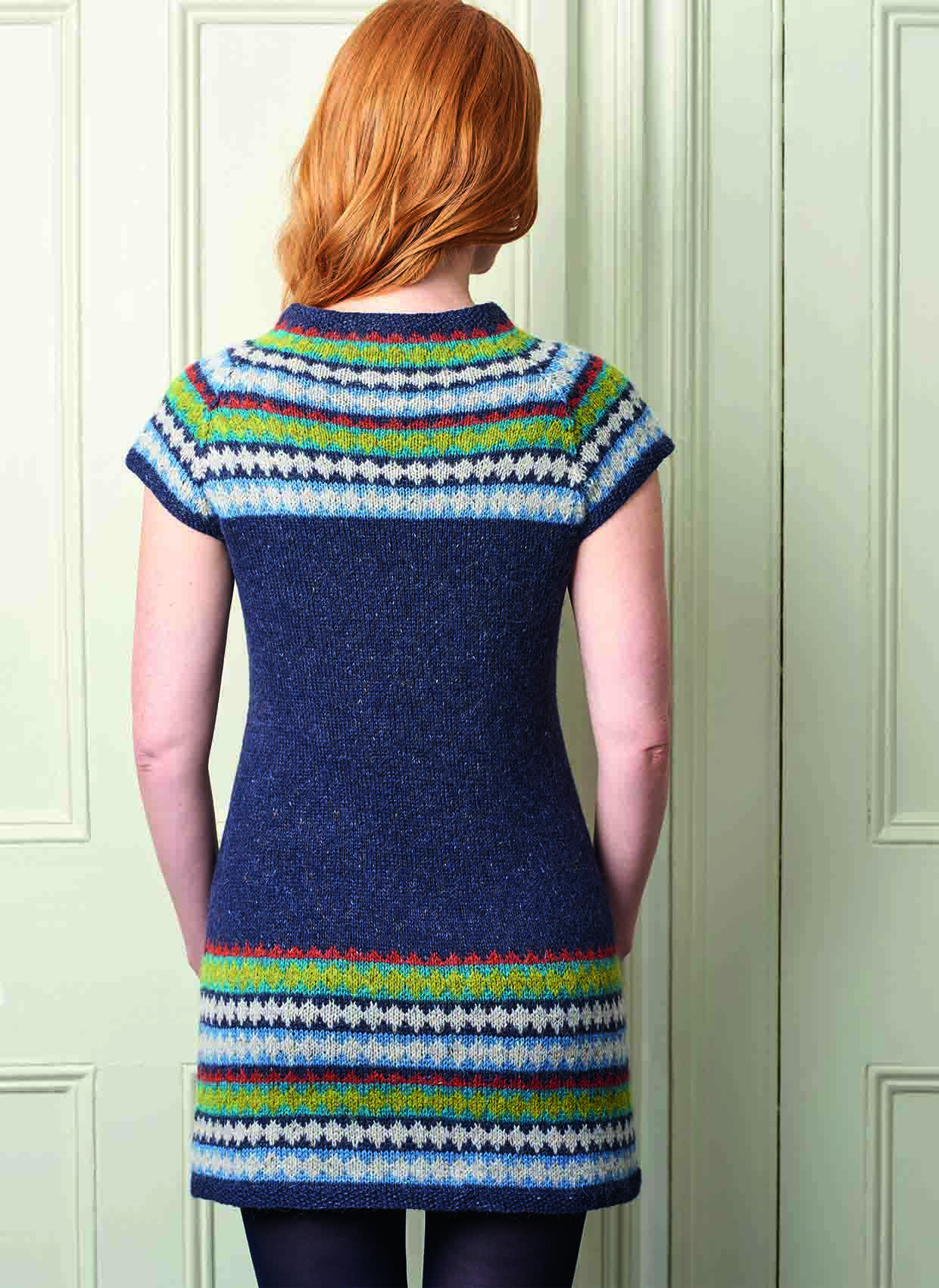 Lady has her back to us so you can see the shaping on the waist at the back of the knitted dress