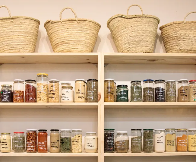 Pantry shelves filled with glass jars of dried goods