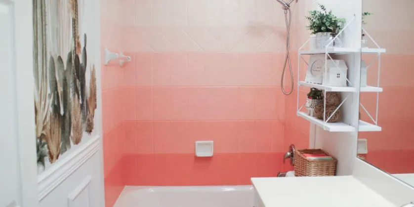 Ombre painted tiles in graduated coral shades in a shower area