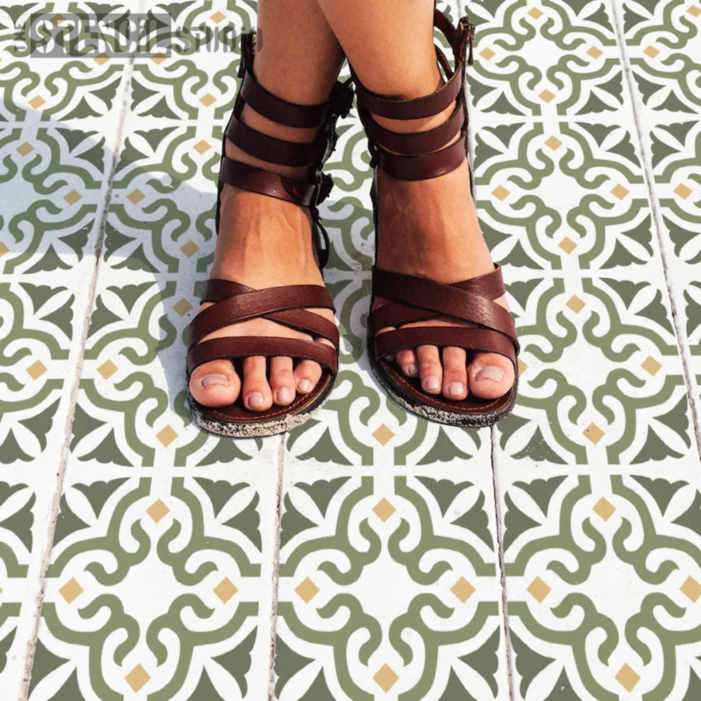 Woman's legs and feet in sandals standing on patterned tiled floor