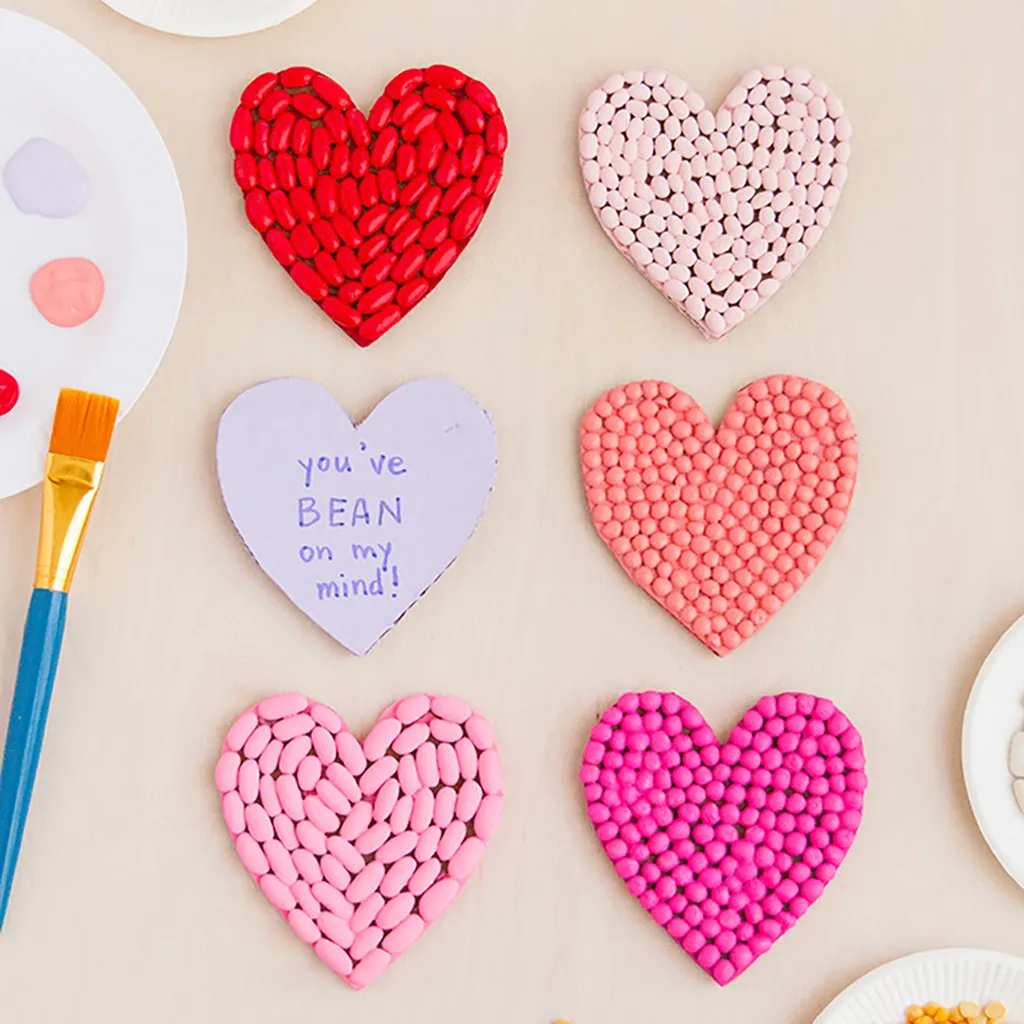 Six hearts decorated with colourful beans - valentines crafts for kids
