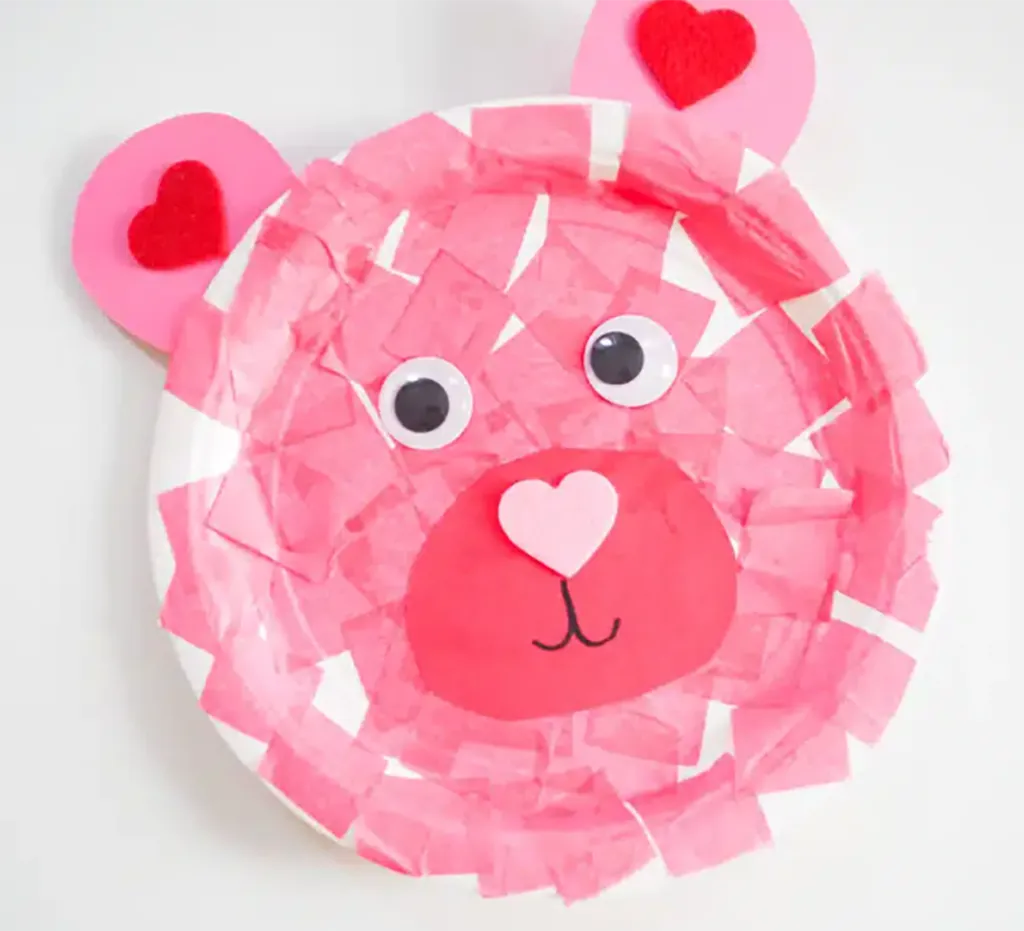 A pink bear made from a paper plate and tissue paper