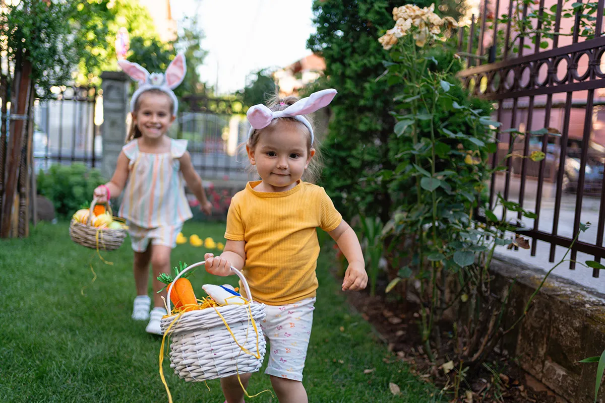 Toddler girl running with an Easter basket full of Easter eggs