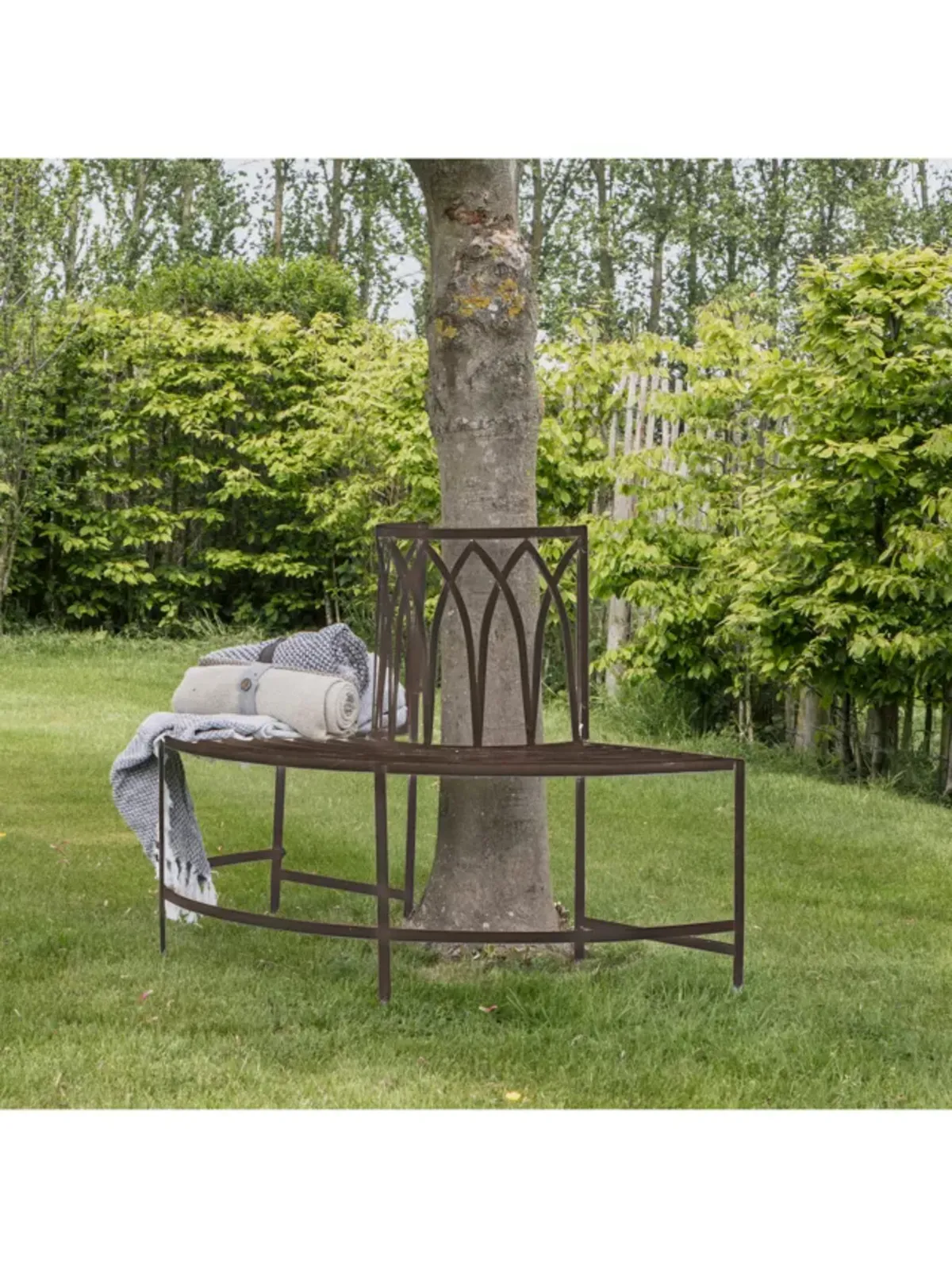Metal semi circle bench seat around a tree trunk