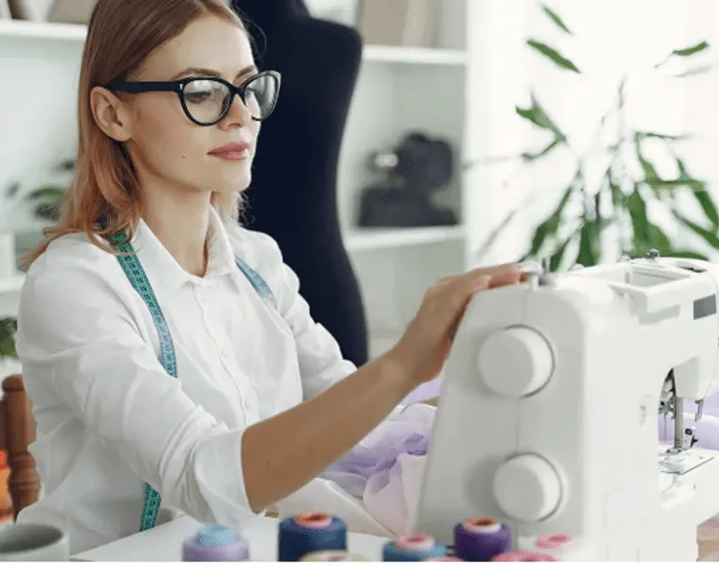 Young woman with glasses setting up her sewing machine