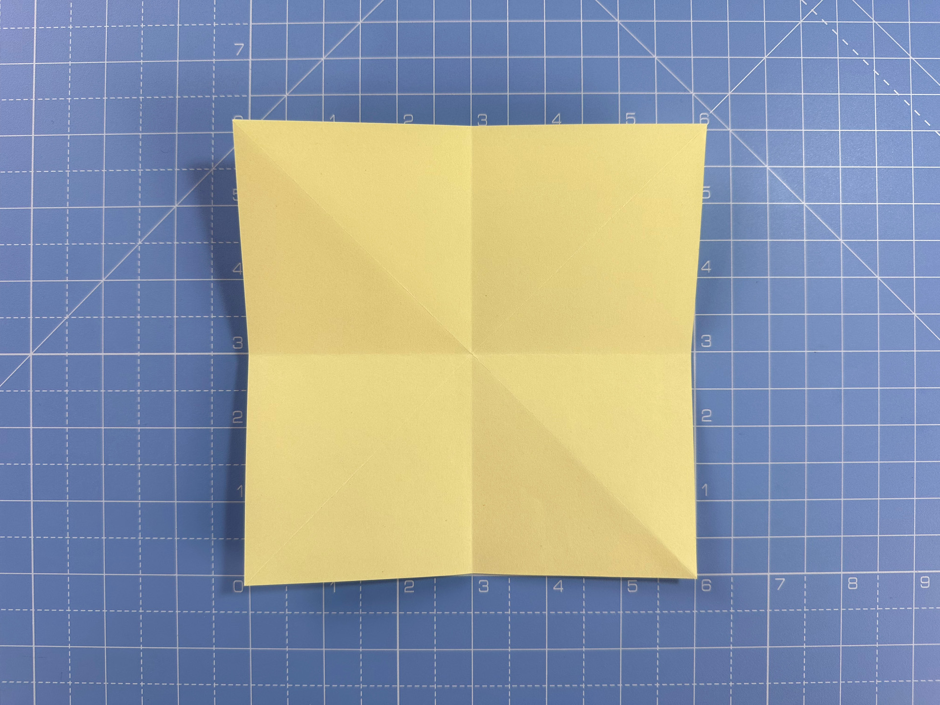 Making an origami flower bud step 13