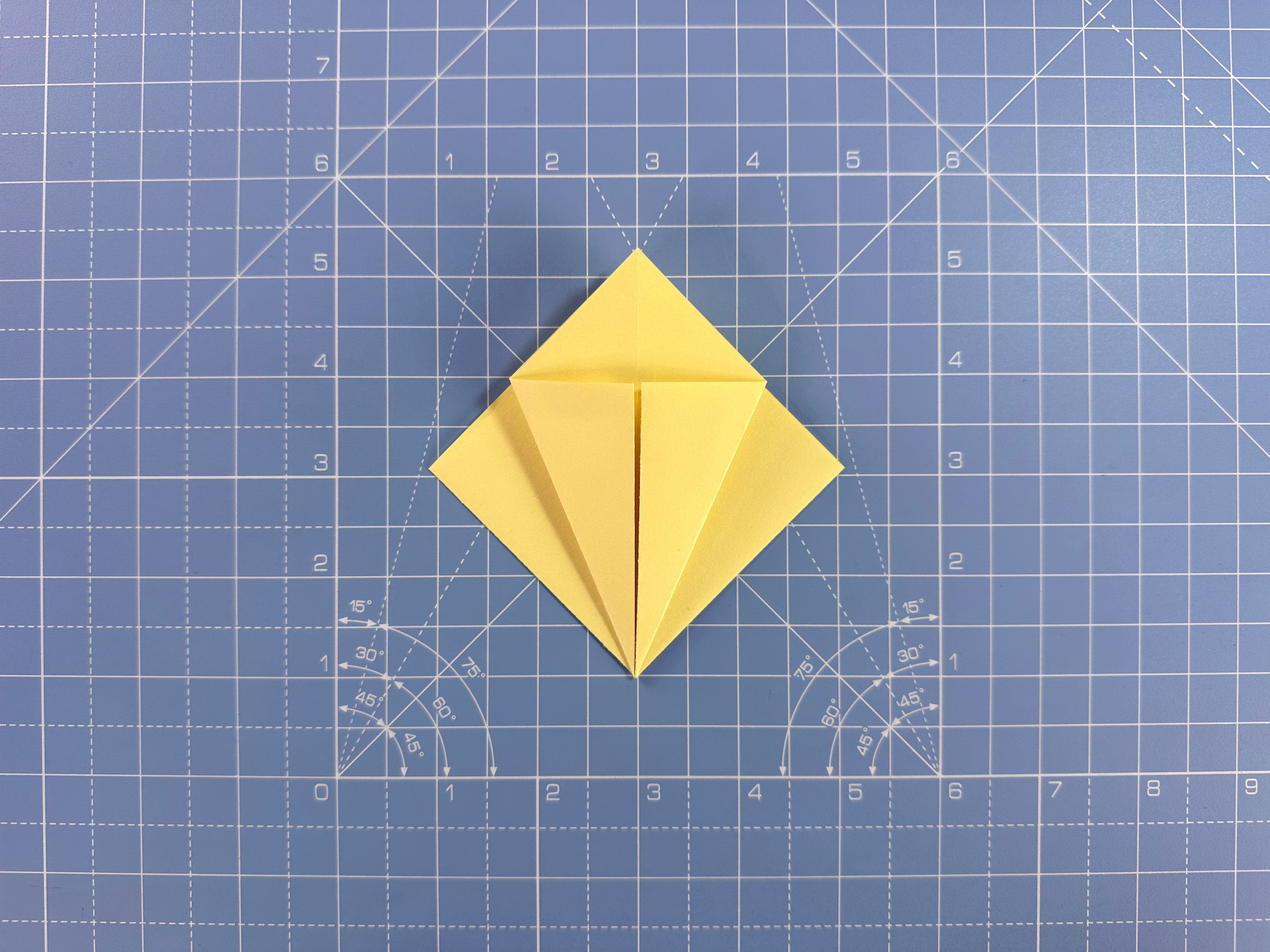 Making an origami flower bud step 15