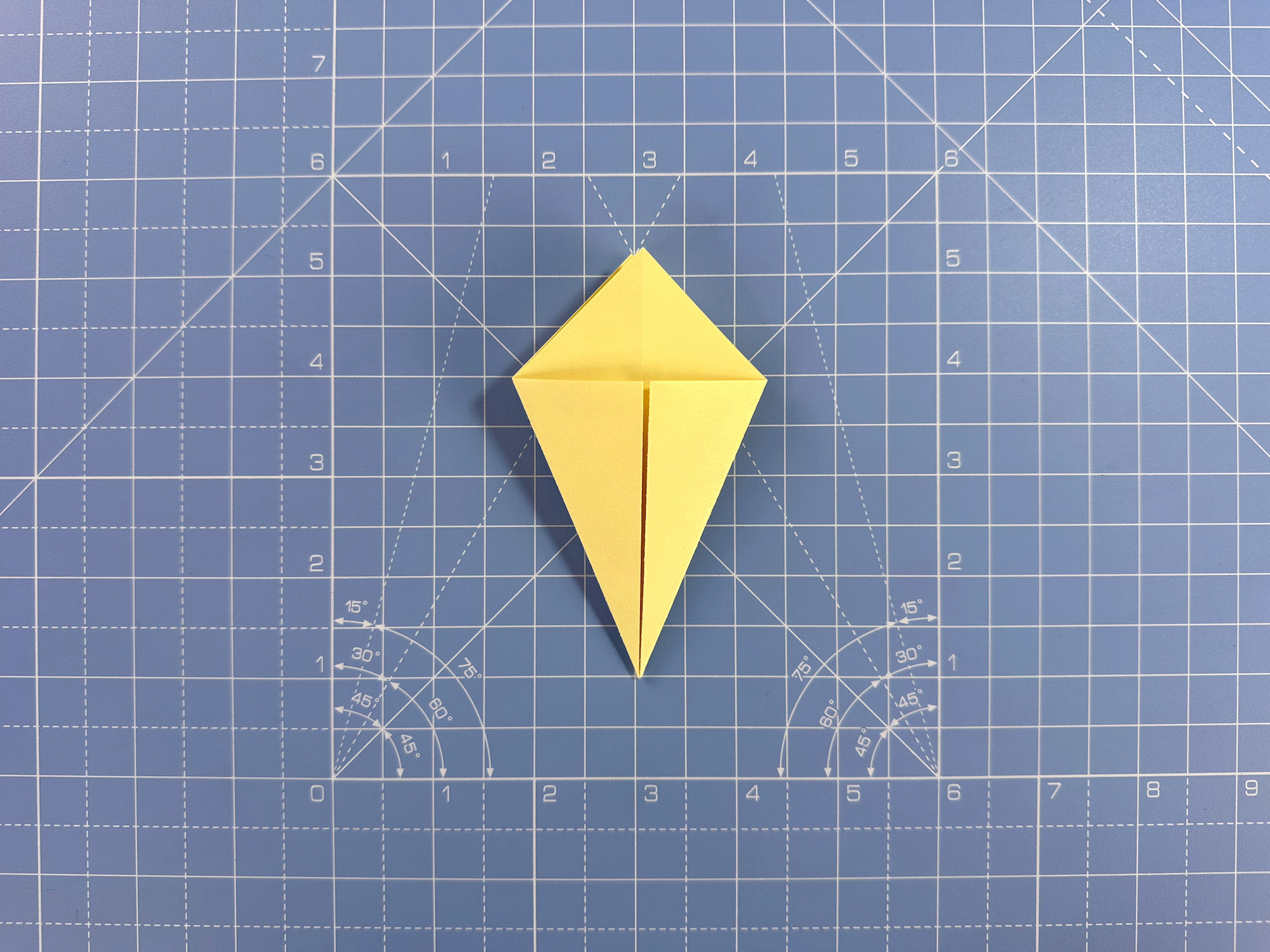 Making an origami flower bud step 16
